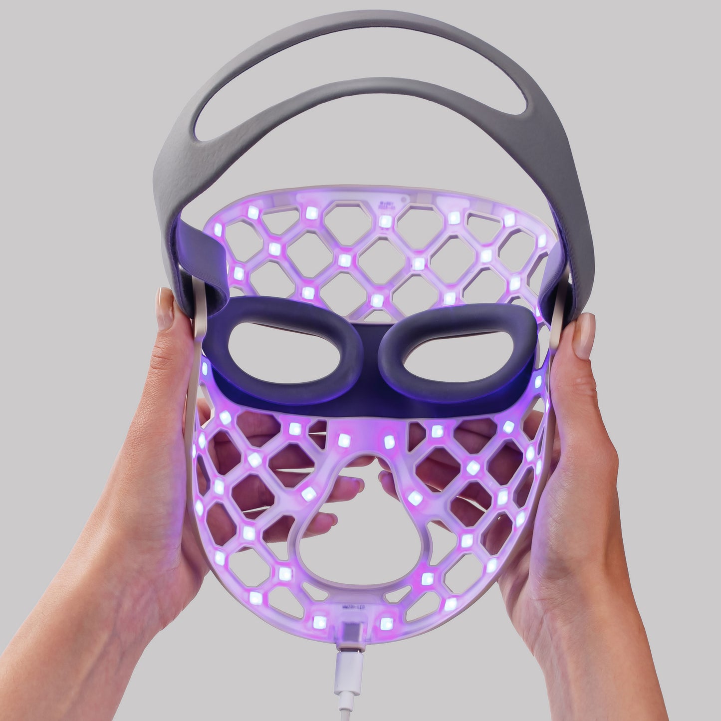 Women holding the LED face mask with blue light