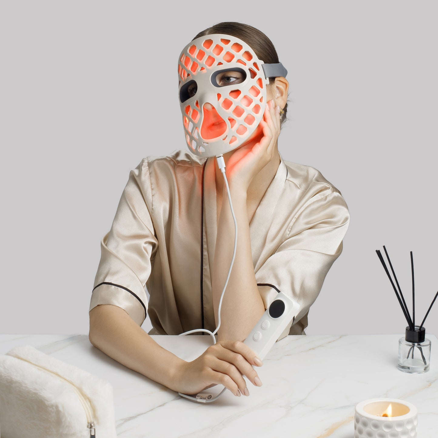 Women wearing a LED face mask with a control device