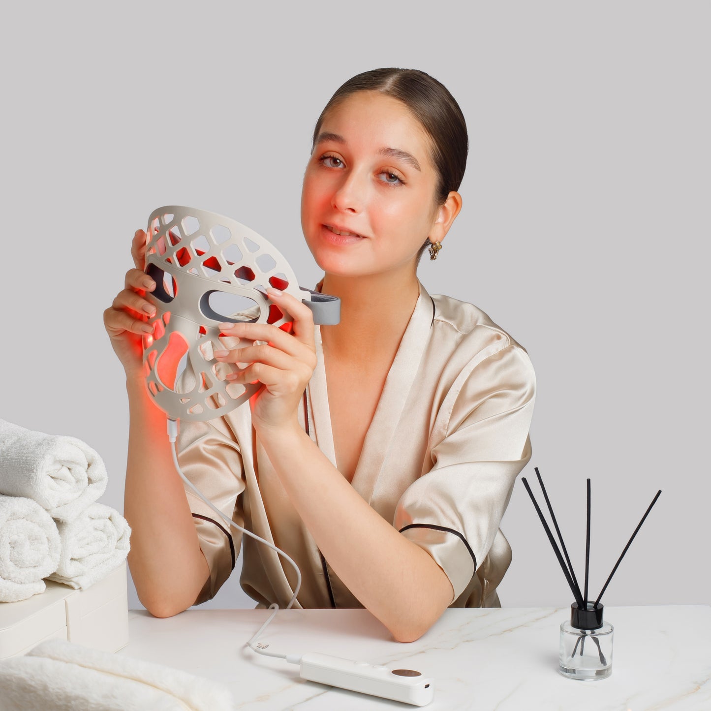 Woman holding a facial LED mask