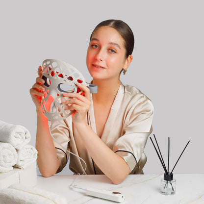 Woman holding a facial LED mask